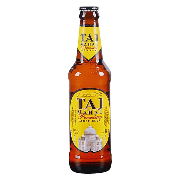 A brown bottle of Taj Mahal Premium Lager Beer with a yellow label featuring the Taj Mahal.
